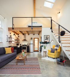 a living room filled with furniture and a stair case