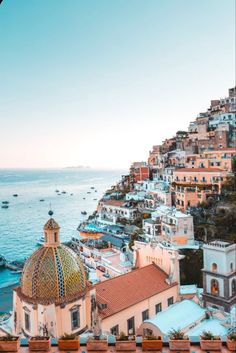 a view of the ocean and buildings from an overlook point in positi, italy