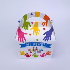 a box with colorful handprints on it and the words hi five for celebrating winter