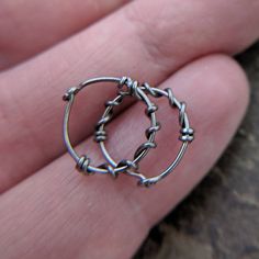 I carefully handform these simple hoops out of 22 gauge (0.644mm) sterling silver, niobium or gold fill wire and smooth the tips then twist a tendril of wire around the hoop for a touch of pretty. Shown: 22g niobium/niobium, 22g niobium/ gold fill, 20g niobium/niobium and 20g niobium/silver The final shot shows the 28g 14k white, 26g 14k yellow, 24g 14k pink, 22g niobium and 20g sterling silver so that you can compare colors and thickness. Listing is for two (2) hoops. Select materials and inner Bronze Small Hoop Earrings With Ear Wire, Wire Wrapped Small Hoop Sterling Silver Earrings, Silver Gold-plated Hoop Earrings With Ear Wire, Artisan Bronze Hoop Earrings With Ear Wire, Bohemian Sterling Silver Wire Wrapped Hoop Earrings, Extreme Metal, Nose Hoop, Mixed Metals, Wire Wrapping