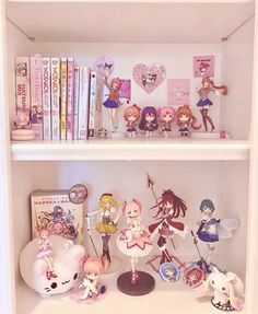 a book shelf filled with anime figurines and other toy items on top of it