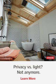 a bathroom with a skylight above it and a bathtub in the middle, next to a window that reads privacy vs light? not anymore learn more