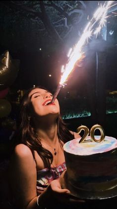 a woman is blowing out the candles on her birthday cake