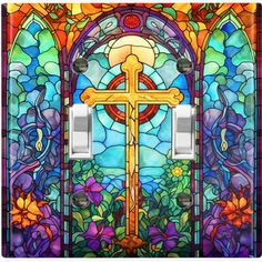 a light switch cover with a cross and flowers in front of a stained glass window