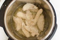 the chicken is being cooked in the pot on the stove top, ready to be cooked