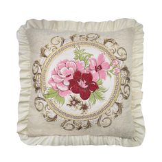 a white pillow with pink flowers on the front and gold trimmings around it