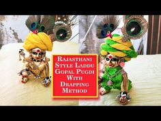 two small figurines sitting on top of a bed next to a sign that says rastani style laddu goal pud with drawing method