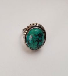 Vintage Southwest green marbled turquoise cabochon beaded sterling ring. Gorgeous deep blue-green colored cabochon, with charcoal grey inclusions, bezel-set with a hammered silver bead frame.  The ring is a size 6 US, and so nicely made! The cabochon is polished, smooth, deep set into an oval bezel which is framed by hammered silver. Minimal decoration for maximum visual impact! The stone is deep and the top of the cabochon sits 3/8 inch off the band of the ring. The cabochon itself measures 5/8 inch tall and 1/2 inch wide, a soft and very visually pleasing size. The ring sits quite comfortably on the hand, nicely balanced with a wide band. Hallmarked "925" on the band. Minimal Decoration, Silver Turquoise Ring, Silver Gift Wrap, Bead Frame, Sterling Silver Rings Turquoise, Turquoise Ring Silver, Crystal Choker, Silver Gifts, Hammered Silver