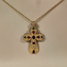 Byzantine style Greek Cross made of 18 carat solid yellow gold with genuine precious gemstones The Cross is decorated with different shapes Rubys,Sapphires,Emeralds and a Diamond 0.10 ct. Total weight of te colored stones is 3.20 ct. The specific Croos has been manufactured in one of the oldest jewelry workshops in Athens which is famous for production of byzantine jewelry It is a handmade Cross with spirals and grains Made in Greece inspaired by Byzantine art jewelry A beautiful piece of jewelr Byzantine Style Jeweled Gold Jewelry, Gold Byzantine Jeweled Jewelry, Byzantine Jeweled Gold Jewelry, Gold Multi-stone Gemstones In Fine Jewelry Style, Gold Multi-stone Fine Jewelry Gemstones, Byzantine Style Cross Jewelry In Yellow Gold, Byzantine Yellow Gold Cross Jewelry, Gold Byzantine Cross Jewelry, Byzantine Multi-stone Jewelry As Gift