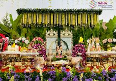 an elaborately decorated stage with flowers and decorations