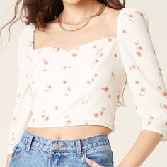 Let Your Top Do The Talking. The Sweetness Is A Cropped, Textured Crepe Floral Print Blouse With A Sweetheart Neckline And An Elastic Puffed Shoulder Detail. It Is Partially Lined With A Hidden Side Zip Closure. Cute Cropped Crop Top With Floral Print, Cute Floral Print Crop Top, Cute Cropped Floral Print Crop Top, White Fitted Ditsy Floral Print Blouse, White Fitted Blouse With Ditsy Floral Print, Cute Fitted Tops For Brunch, Cute Fitted Blouse For Brunch, Cute Tops With Ditsy Floral Print For Day Out, Cute White Square Neck Top