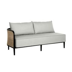 a white couch with two pillows on the back and one arm folded up to it's side