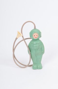 a small green toy with a white background