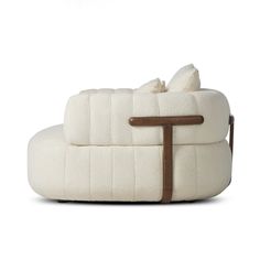 a white couch sitting on top of a wooden table