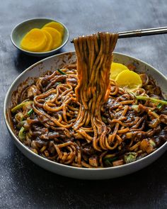 a bowl filled with noodles and sauce on top of a table