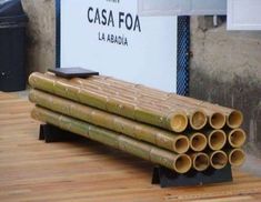 several bamboo pipes stacked on top of each other in front of a sign that says casa foa