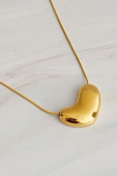 This Bold Molten Heart Necklace is as stylish as it is eye-catching. Featuring an impressive dimensionally rounded heart pendant hung on a round herringbone chain, it is sure to make any outfit stand out. Material Composition: 18k gold plated stainless steel, water and tarnish resistant Lead and Nickel free Imported Herringbone Chain, Gold Heart Necklace, Steel Water, Heart Necklace, Heart Pendant, Herringbone, 18k Gold, Gold Plate, Composition