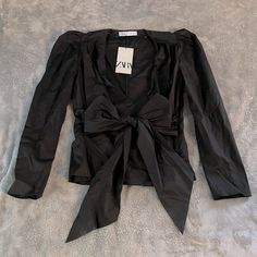 New With Tags! No Signs Of Wear Or Discoloration. Us Size Medium. Side Zipper With Bow In Front Which Is Adjustable. Slight Poof In The Shoulders. Long Sleeves. 97% Cotton 3% Elastic. Such A Cute Top! Zara Black Long Sleeve Blouse, Black Spring Workwear Blouse, Black Spring Blouse For Work, Black Workwear Blouse For Spring, Zara Casual Party Blouse, Black Spring Office Blouse, Spring Office Black Blouse, Zara Evening Blouse For Spring, Zara Blouse For Evening In Spring