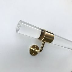 a close up of a light fixture on a white wall with a gold colored handle