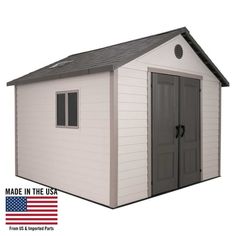 a white storage shed with an american flag on the side and black door, made in the usa