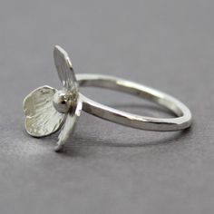 A sweet little flower handmade from sterling silver adorns this beautiful ring.  Hand fabricated from sterling silver sheet, hand sawed, forged, textured, soldered and polished.  It's a labor of love.  Each flower is unique and one of a kind.  Size 8.5 US-This ring can not be resizedSolid 925 Sterling SilverBand width 2mm, lightly hammeredArtisan made in TexasArrives thoughtfully packaged in a signature jewelry boxCheck out all of my handmade rings:  https://www.etsy.com/shop/KMBankston?ref=em&a Handmade Sterling Silver Petal Jewelry, Dainty Handmade Silver Flower Ring, Minimalist Sterling Silver Flower Ring, Delicate Handmade Silver Flower Ring, Sterling Silver Minimalist Flower Ring, Handmade Sterling Silver Rings With Flower Shape, Nature-inspired Sterling Silver Flower Ring, Handmade Delicate Silver Flower Ring, Handmade Sterling Silver Flower Ring