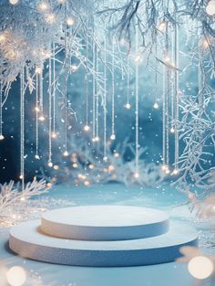 a white circular object sitting on top of a blue surface next to snow covered trees