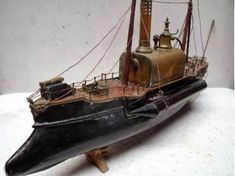 an old model boat is sitting on a table