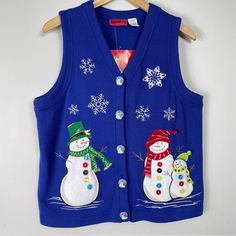 a blue sweater vest with snowmen on it