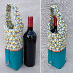 two bottles are sitting next to each other in front of a wine bottle holder that has a flower pattern on it