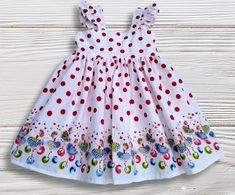 Beautiful sundress in a white fabric with red polka dots with a ballerina theme at hem.  Dress is done in a white cotton fabric with red polka dots, ballerinas theme with flowers and butterflies at hem.   Dress closes in the back with buttons, bodice fully lined, skirt has plenty of fabric, straps at shoulder with ruffles, we finish all seams with a serger for a professional look and long lasting. Please check size chart before ordering. All our items are handmade and made to order. Created in a Cute White Ruffled Sundress, White Playful Twirl Dress For Summer, White Flutter Sleeve Twirl Dress For Summer, Red Summer Dress For Birthday, Playful White Twirl Dress For Summer, White Flutter Sleeve Twirl Dress For Spring, White Summer Twirl Dress With Flutter Sleeve, White Summer Twirl Dress With Ruffles, Cute White Twirl Dress With Flutter Sleeves