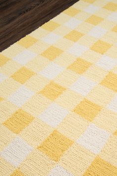 a yellow and white checkered rug on the floor