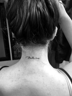 a woman with a tattoo on her back neck