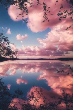 the sky and clouds are reflected in the water