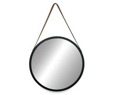 a round mirror hanging on a wall