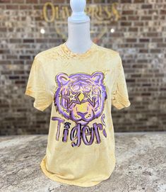 Comfort Colors Color Blast Yellow Tshirt with Purple and yellow preppy tiger and gold foil accents! Comfort Colors T-shirts are Pre-Shrunk For best foil care, machine wash cool water, low heat or hang to dry, and no fabric softeners. Color Blast shirts are not available in youth sizes! Youth sizes will be printed on a plain yellow comfort colors tshirt. Trendy Gold Summer T-shirt, Trendy Gold T-shirt For Summer, Spring Gold Graphic Print T-shirt, Gold Letter Print Top For Summer, Gold Letter Print Tops For Summer, Trendy Gold Tops With Graphic Print, Gold Graphic Tee Tops For Summer, Gold Crew Neck Top With Screen Print, Trendy Gold Crew Neck T-shirt