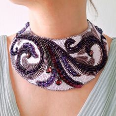 Purple embroidered necklace. Beaded collar. Bridal boho style necklace. Statement necklace. Choker necklace. Dimensions: 2,75 inches (7 cm) wide at the widest point, 13,4 inches (34 cm) long + 24.4 inches (62cm) ribbon from each side. Closure - velour ribbon. Materials: Czech beads, Japanese beads, crystals, beads of different shapes, sequins, eco-suede, ribbon. We will pack securely and ship within 1-2 business days. An elegant and sophisticated purple embroidered necklace with a stunning combi Beaded Necklaces As Wearable Art Gifts, Beaded Necklaces As Wearable Art For Gifts, Beaded Necklace As Wearable Art Gift, Wearable Art Beaded Necklace As A Gift, Elegant Embroidered Festival Jewelry, Elegant Embroidered Jewelry For Festival, Traditional Handmade Purple Beaded Necklaces, Bohemian Multicolor Embroidered Beaded Necklaces, Bohemian Embroidered Party Jewelry