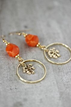 Unique feminine pair of earrings was made of bright orange faceted beads, open circle gold tone charms, gold tone tree charms,gold tone separators, gold tone (brass base) earring hooks. Earring hooks are from nickel free and lead free metal. Wonderful jewelry for you or a great gift for someone special! *The total lenght of earrings is about 67 mm. Other earrings of my shop you can see here: https://www.etsy.com/shop/NaTavelli?section_id=13757927 Thanks for visit. Gold Czech Glass Dangle Flower Earrings, Gold Dangle Flower Earrings With Czech Glass, Gold Nickel-free Czech Glass Flower Earrings, Nickel-free Gold Czech Glass Flower Earrings, Nickel-free Gold Flower Earrings With Czech Glass, Gold Czech Glass Flower Earrings For Gift, Nickel Free Gold Earrings With Czech Glass, Gold Round Beads Flower Earrings As Gift, Nickel-free Gold Earrings With Czech Glass