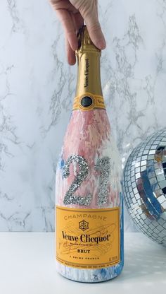 a bottle of champagne being held by a hand