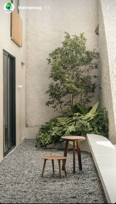 an empty courtyard with tables and benches next to the building's entryway,