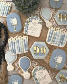 decorated cookies with blue and gold icing on a table