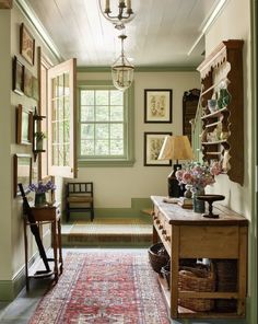 the hallway is decorated with antique rugs and other decorating items, including an old - fashioned lamp