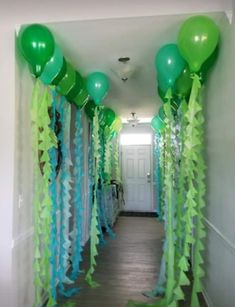 green balloons and streamers line the hallway