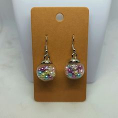 These Earrings Are Tiny Faux Pearls In 18mm Glass Globes. Sterling Silver-Coated Hooks. Purple Glass Dangle Earrings, Trendy Purple Round Earrings, Party Earrings In Multicolor Glass, Multicolor Glass Earrings For Party, Purple Resin Drop Earrings, Round Glass Earrings For Parties, Party Glass Multicolor Earrings, Party Glass Earrings In Clear Color, Globe Earrings