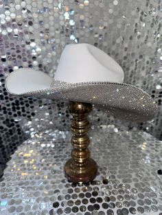 The original Rhinestone Cowgirl hat is our #1 seller!! Perfect for any concert, Nashville trip, bachelorette party, bride or just because! This hat will match every outfit you have and is truly a show stopper! This hat features: White straw hat Crystal rhinestones on the underneath brim ONLY Matching crystal hat band Sizing: Our white hats are a one size fits all! The band on the inside is a stretchy band; all orders come with a custom Rhinestone Cowgirl dust bag and foam pieces that can be stuc Rhinestone Cowgirl Hat, Crystal Hat, White Hats, Rhinestone Cowgirl, Custom Rhinestone, Suede Hat, Nashville Trip, Bridal Hat, Bachelorette Party Bride