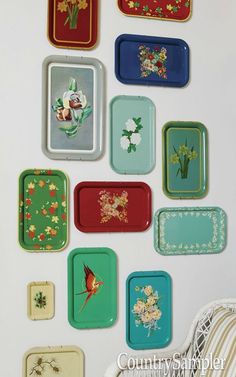 the wall is decorated with many colorful trays and flower designs on each one side