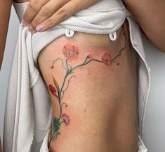 a woman's stomach with flowers on it and the bottom part of her body