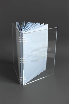 a clear book with blue pages on it