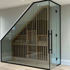 a room that has some shelves inside of it with wine bottles on the bottom shelf