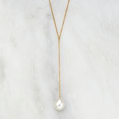 LILY & ROO's large pearl lariat necklace. This beautiful pearl necklace is made with a 14ct gold-filled chain and a beautiful hand-selected freshwater pearl. The perfect jewellery gift for her that will complement any outfit. All large gold single pearl necklaces come in a luxury LILY & ROO gift box. Gold Filled means a layer of pure gold pressure-bonded to the core metal. Gold-filled items are 5 to 10 times thicker than gold plating. Give your jewellery a little TLC to keep your jewellery shini Lariat Necklaces, Lariat Necklace Silver, Pearl Lariat Necklace, Pearl Lariat, Single Pearl Necklace, Gold Lariat Necklace, Beautiful Pearl Necklace, Pearl Drop Necklace, Handmade Rose