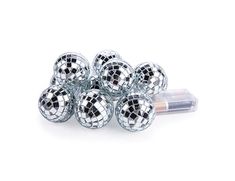 silver disco balls are stacked on top of each other in front of a white background